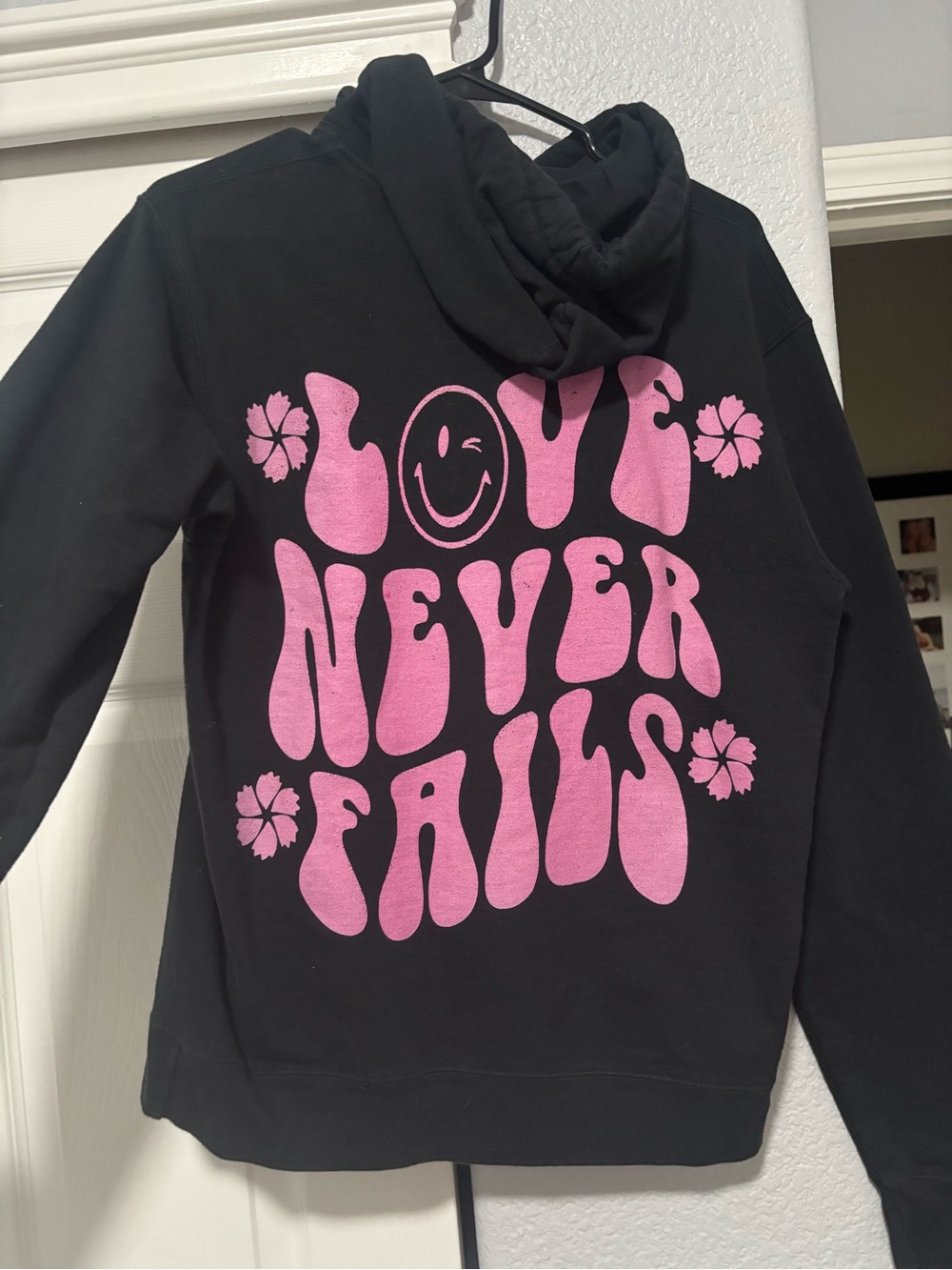 LOVE NEVER FAILS SWEATSHIRT